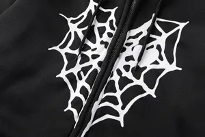 Gros plan détail du sweat à capuche zippé noir avec imprimé toile d'araignée cœur.