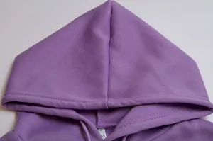 Purple hoodie sweatshirt detail close-up showing hood, drawstring, and collar size tag.