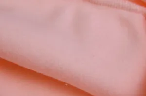 Pink fleece fabric detail macro shot, soft plush texture closeup for women hoodie garment.