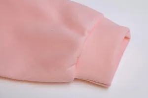 Detailed close-up view showing the pink women fleece hoodie ribbed cuff fabric texture.
