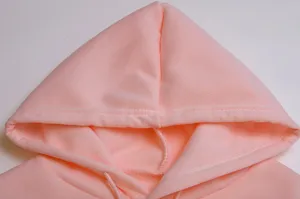 Pink fleece hoodie hood detail closeup, soft fabric and adjustable drawstring design.