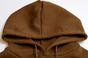Brown fleece hoodie detail shot, cozy fabric and adjustable drawstring design close up.