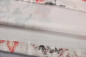 Close-up detail of floral print fabric dress with exquisite hem stitching and fine lining.