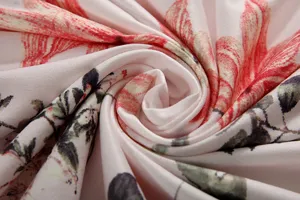 Detailed view of the pink floral printed fabric with vibrant red flowers and leaves.
