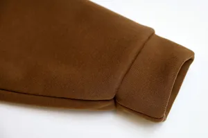 Brown fleece hoodie sleeve cuff detail shot showcasing thick knit texture and comfortable fit.