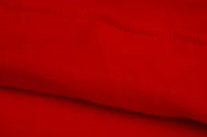 Red fleece hoodie fabric detail close up showing soft plush texture and fine stitching.