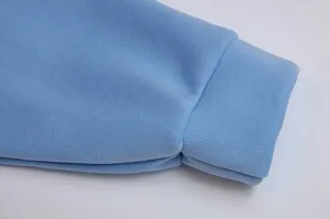 Light blue hoodie cuff detail, soft fleece fabric texture, neat ribbed design close-up view