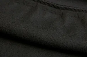 Close up of black fleece fabric detail, showing soft inner lining texture and neat stitching.