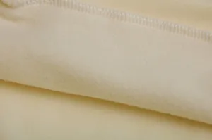 Close up view of the soft fleece inner lining and neat stitching detail of a women hoodie.