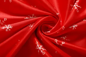 Weihnachtlicher Schneeflocken Druck Stoff Detail in Rot fuer winterliche Kleider.