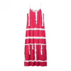 Close-up detail of the red and white tie-dye maxi dress strap and neckline design.