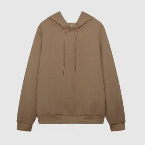 Detail view of the autumn jacquard hooded drawstring long sleeve loose brown sweatshirt.