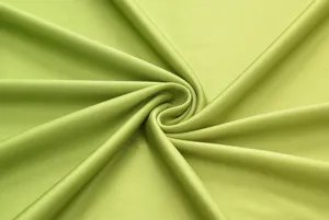 High-resolution detail shot of smooth light green fabric swatch, soft texture and elegant drape.