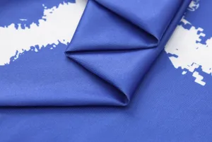 Detailed close-up view of the smooth blue fabric texture with white abstract print design.