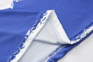 Blue white printed dress detail close up showing fine stitching and soft fabric texture.