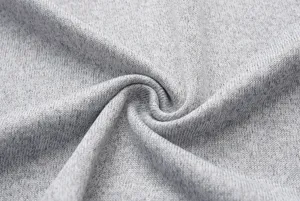 Detailed close-up shot of soft grey knit fabric texture with natural twisted folds.