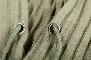 Close-up detail of knitted ribbed hoodie with metal eyelets and matching drawstrings.