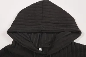 Black ribbed knit hoodie detail close up showing hood and collar structure for autumn style.