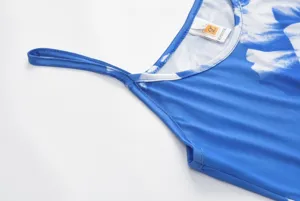 Detailed close-up view of the blue floral print camisole dress strap and neckline.