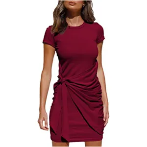 Close up display of the burgundy short sleeve ruched dress featuring bow waist detail.