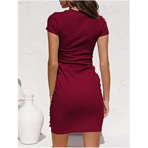 Back view detail of a chic burgundy short sleeve dress featuring ruched side design.