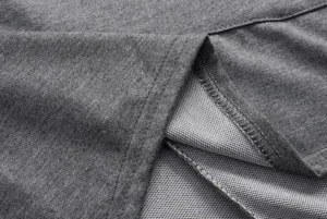 Close-up detail of grey fabric hoodie texture, showing fine stitching and inner lining quality.