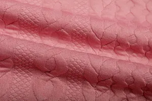 Close-up detail of the premium pink jacquard fabric texture, showing fine knit craftsmanship.