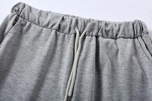 Detail view of women's casual grey trousers elastic waistband with adjustable drawstring.