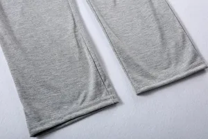 Grey casual trousers cuff detail shot, soft knit fabric with fine stitching and clean finish.