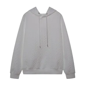 Detailed view of white jacquard knit hoodie featuring long sleeves and adjustable drawstring hood.