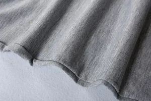 Close up of grey knitted fabric texture, soft material detail shot for casual clothing.