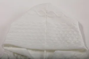 Detailed close-up view of white hoodie knit hood, textured jacquard fabric pattern.