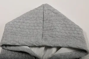 Detailed view of gray jacquard hooded sweatshirt, showing texture and quality craftsmanship.