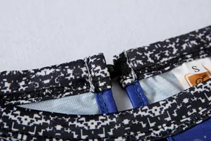 Women's casual long sleeve top collar detail close-up showing button closure and size tag.