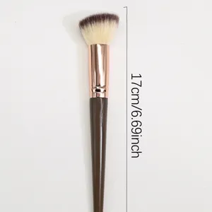 Close-up detail of the angled makeup brush showing soft bristles and rose gold ferrule.