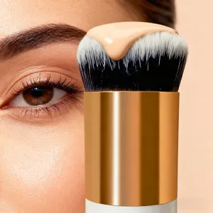 Professional foundation makeup brush with dense bristles and golden handle for smooth liquid makeup.