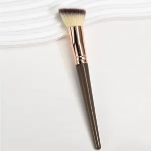 Professional angled makeup brush with brown handle and soft bristles for flawless foundation.