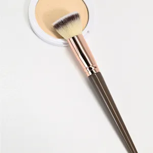 Angled foundation makeup brush detail view showing soft dense bristles and rose gold ferrule.