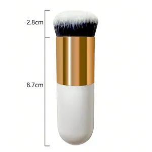Detail view of the portable fat makeup brush with soft bristles and gold handle.