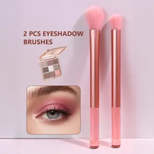 Detailed view of 2pcs professional pink eyeshadow makeup brushes set with soft bristles and handles.