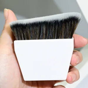 Detailaufnahme eines weißen Griffes flachen Foundation Pinsel mit welligen Borsten.