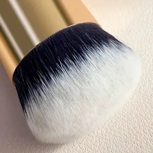 Detailed view of dense makeup foundation brush with soft black and white gradient bristles.