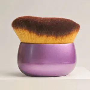 Detailed close-up of the soft bristled cosmetic brush with purple base and dense wavy hairs.