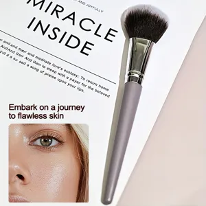 Detail shot of the olive purple makeup brush with soft bristles and sleek gray handle.