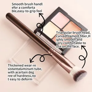 Triangular makeup foundation brush detail with soft curved fibers and comfortable grip handle.