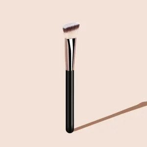 Detailed shot of an angled foundation brush with soft bristles and sleek black handle.