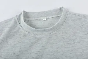 Grey knit t-shirt collar close-up showing soft fabric texture and size tag for daily wear.