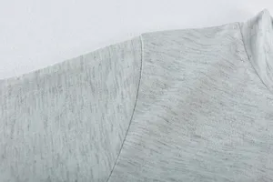 Close-up detail of soft heather gray knit fabric, fine texture and neat stitching for apparel.