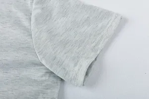 Gray melange fabric short sleeve detail close-up, premium stitching texture and fine knit fabric.