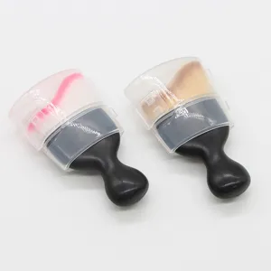 Detailed view of portable makeup brush with clear cover and ergonomic black handle.